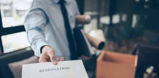 employee handing over a resignation letter