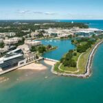 aerial view of a lakeside university campus with lagoon and curved shoreline
