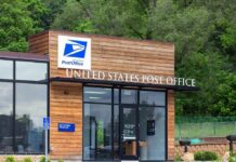 Gun Ban Whiplash Stuns Mail Lines Exterior view of a modern United States Post Office building surrounded by greenery