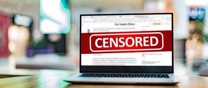 Laptop screen with a large censored banner