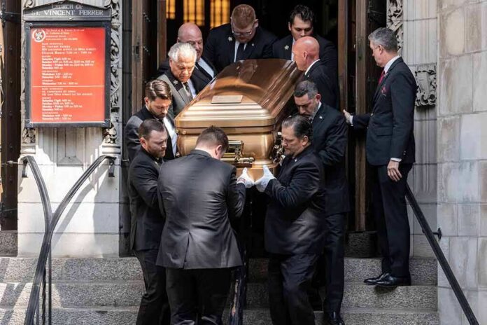 shutterstock_2180696057 Pallbearers carry a casket down church steps