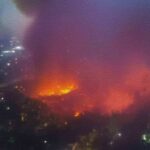 Aerial view of large urban fire at night
