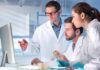Fire Amoeba Defies Biology’s Hard Limit Scientists in lab coats reviewing data on a computer
