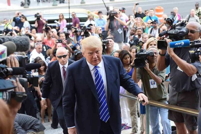 shutterstock_307005071 Donald Trump walks up steps through a crowd as A. J. Calloway films nearby