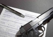 Survey Bombshell Rattles Gun Debate Handgun on firearm transaction form with pen