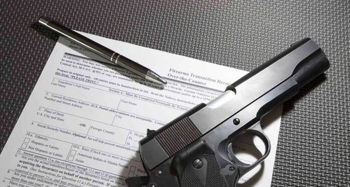 shutterstock_581003293 Handgun on firearm transaction form with pen