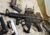 Massive Arsenal Upends Gun Debate Assault rifle and handguns on tactical gear