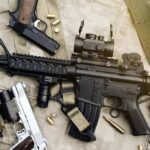 Assault rifle and handguns on tactical gear