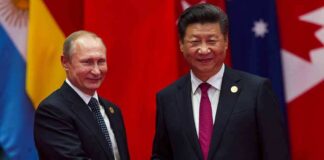 two men in suits shaking hands