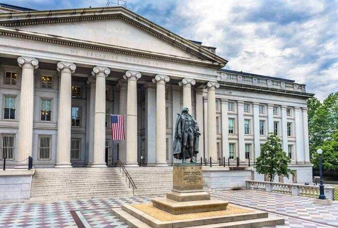 Neoclassical government building with columns and a central bronze statue