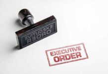 Trump Orders Rapid Women’s Health Overhaul Rubber stamp leaving a red executive order imprint on white paper