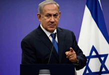 Election Bombshell: Trump Backs Netanyahu man in suit speaking at a podium with an Israeli flag