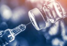 Vaccines Under Anesthesia Sparks Fury syringe needle drawing liquid from a vaccine vial