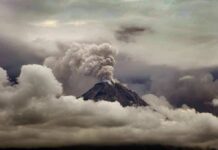 Eruption Spree Rattles Indonesia Volcano erupting with ash plume above cloud layer