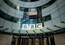 BBC Closes Three Broadcast Channels Amid £500 Million Cuts BBC headquarters entrance with curved glass facade