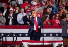 Red-State Alarm: Nebraska Suddenly In Play Donald Trump points from a rally stage; Rudi Koertzen and Bear Pascoe are in the crowd