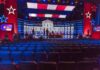 SHOCKING Reversal: Top Dems Shift on Sports Debate stage with red and blue lighting and empty audience seats