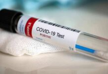 COVID-19 test tube labeled positive on gauze