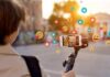 Person livestreaming with smartphone on gimbal outdoors