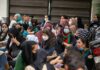 Border Backlash Over Taxpayer-Funded Hijabs Chuck Howley among a seated crowd of masked women outdoors