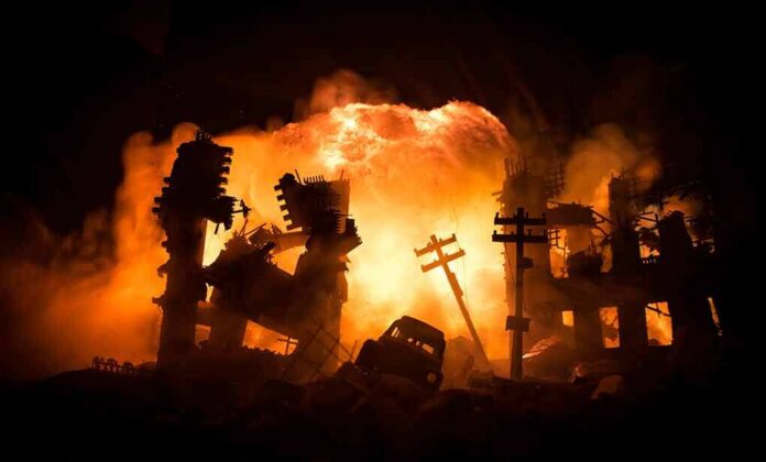 shutterstock_2082466771 City ruins ablaze with a massive explosion behind collapsed buildings
