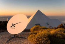 Starlink satellite dish near a pyramid-shaped building at sunset