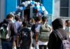 Snapchat Leak Triggers Felony Firestorm Students with backpacks enter a school under a balloon arch