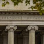 Neoclassical building facade with Ionic columns and engraved frieze