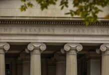 Neoclassical building facade with Ionic columns and engraved frieze