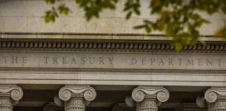 Neoclassical building facade with Ionic columns and engraved frieze