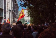 Housing Uprising Ignites Barcelona Streets Crowd with Spanish flags in a city street
