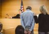 Judge Hammers Smuggler After Carnage Defendant in handcuffs stands before a judge in a courtroom