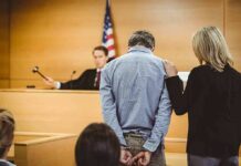 Judge Hammers Smuggler After Carnage Defendant in handcuffs stands before a judge in a courtroom