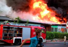 Downtown Fireball Engulfs Quaker Plant Firetruck at a building engulfed in flames