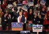 Impeach Uproar After Trump’s ‘Fight Back’ Blast Donald Trump addresses a rally crowd at a podium, raising his fist