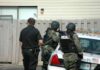 Philly Ambush Carnage Stuns City police officers in tactical gear beside patrol car